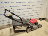 an image of a lawn mower parked in a garage