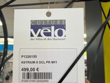 a person holding a bicycle wheel with a price tag attached to it