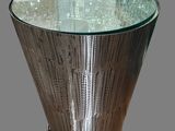 a glass table with a metal base and a glass top