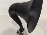 an old black gramphone sitting on top of a white table