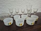 a table with a bunch of cups and glasses on it