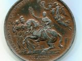 une vieille pièce de monnaie sur laquelle figure l'image d'un homme à cheval