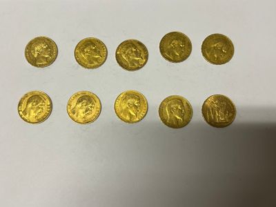 a bunch of gold coins sitting on top of a white table