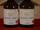 two bottles of wine that are sitting on a table