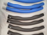 five blue and black plastic handles on a white sheet