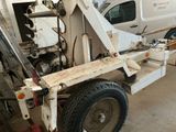 a picture of a tow truck with a flat bed in a garage