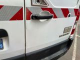 a white van with red and white stripes parked in a parking lot