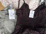 a lot of clothes on a table with a price tag