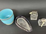 a blue cup, a teapot, and a tea strainer sitting on a table