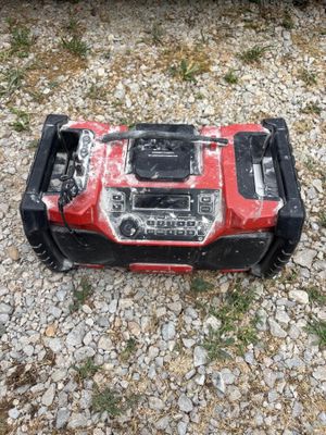 a red and black lawn mower sitting on the ground