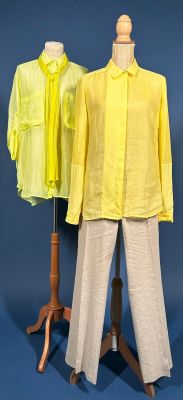 two mannequins wearing yellow shirts and pants on a blue background