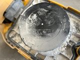 someone is using a circular saw to cut a hole in a piece of metal