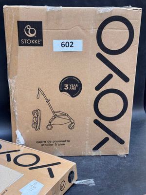 two boxes are sitting on a table in front of a laptop
