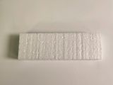 a close up of a piece of paper on a white surface