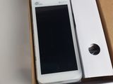 a white cell phone in a box on a table