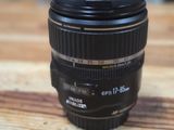 the camera lens is sitting on a wooden table with a blurry background