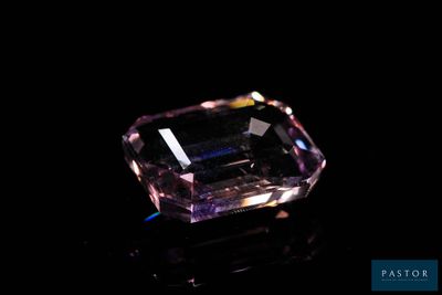 a pink diamond on a black surface