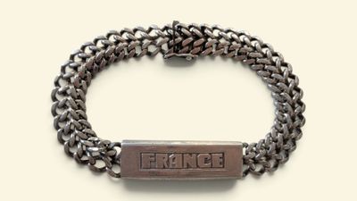 a close up of a bracelet with a bar on it