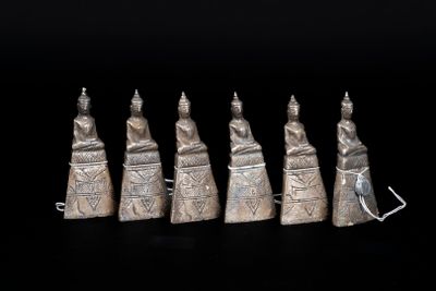 five silver figurines of people in the form of hands