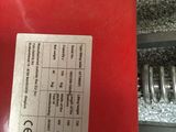 a close up of a red metal object with a label on it