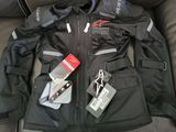 a black jacket with tags on it sitting on a couch