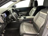 the interior of a car with a steering wheel and a center console