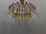 a glass chandelier hanging from a ceiling
