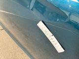 a sticker on the side of a blue car