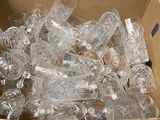 a cardboard box filled with clear plastic bottles