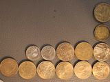 a lot of coins on the table next to each other