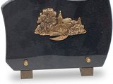 a black and gold plaque with a boat on it