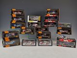 many different models of cars in boxes on the table