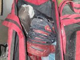 a red and black bag with a baseball glove inside of it