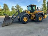the back end of a yellow construction vehicle parked in a parking lot