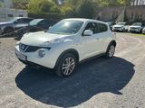 a white nissan juke parked in a parking lot
