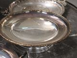 three silver dishes on a silver tray on a table