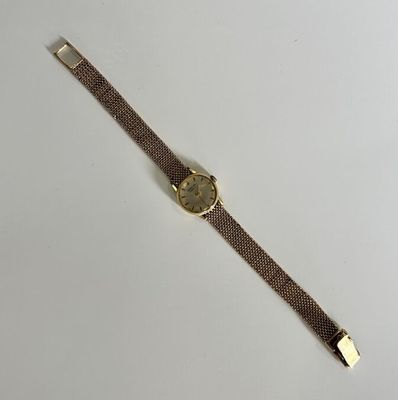 a close up of a wrist watch on a white surface