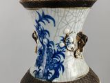 a blue and white vase sitting on a table