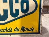 a yellow and green sign on the side of a building