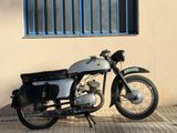 a motorcycle parked in front of a building next to a window