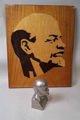 a bust of a man on a table next to a picture of a man