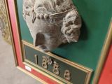 a picture of a statue of a head on a wall