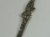 a silver bracelet with a chain attached to it
