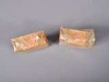 two pieces of bread wrapped in plastic on a table