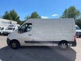 a white van parked in a parking lot with other vehicles in the background