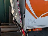 a truck that has a large orange and white logo on it