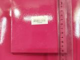 a pink box with a ruler on top of it