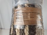 a roll of yarn wrapped in plastic on a table