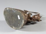 a silver object with a stone on it