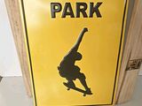 a skate park sign hanging on the wall of a room